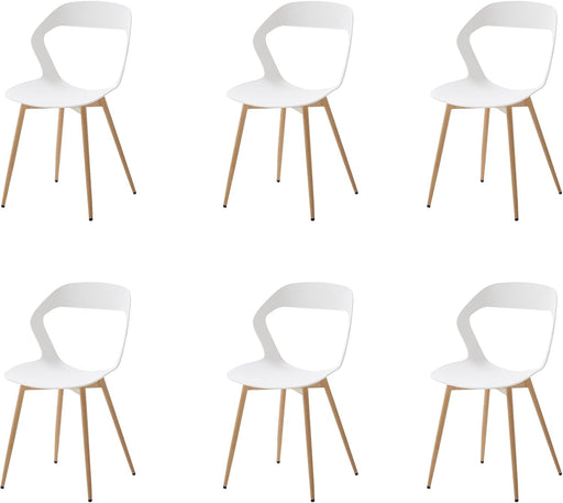 Set of six white dining chairs with a hollow carved backrest design and natural metal legs, arranged around a modern dining table.