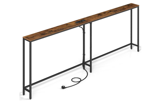 A long industrial console table with a rustic brown wood top and a black metal frame, featuring an integrated power outlet on the tabletop and a coiled power cord on the floor, shown on a white background.