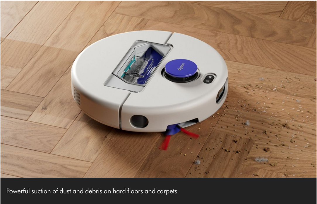 A white robotic vacuum cleaner with a blue power button is shown on a wooden floor, picking up dust and debris. A black banner at the bottom contains descriptive text.