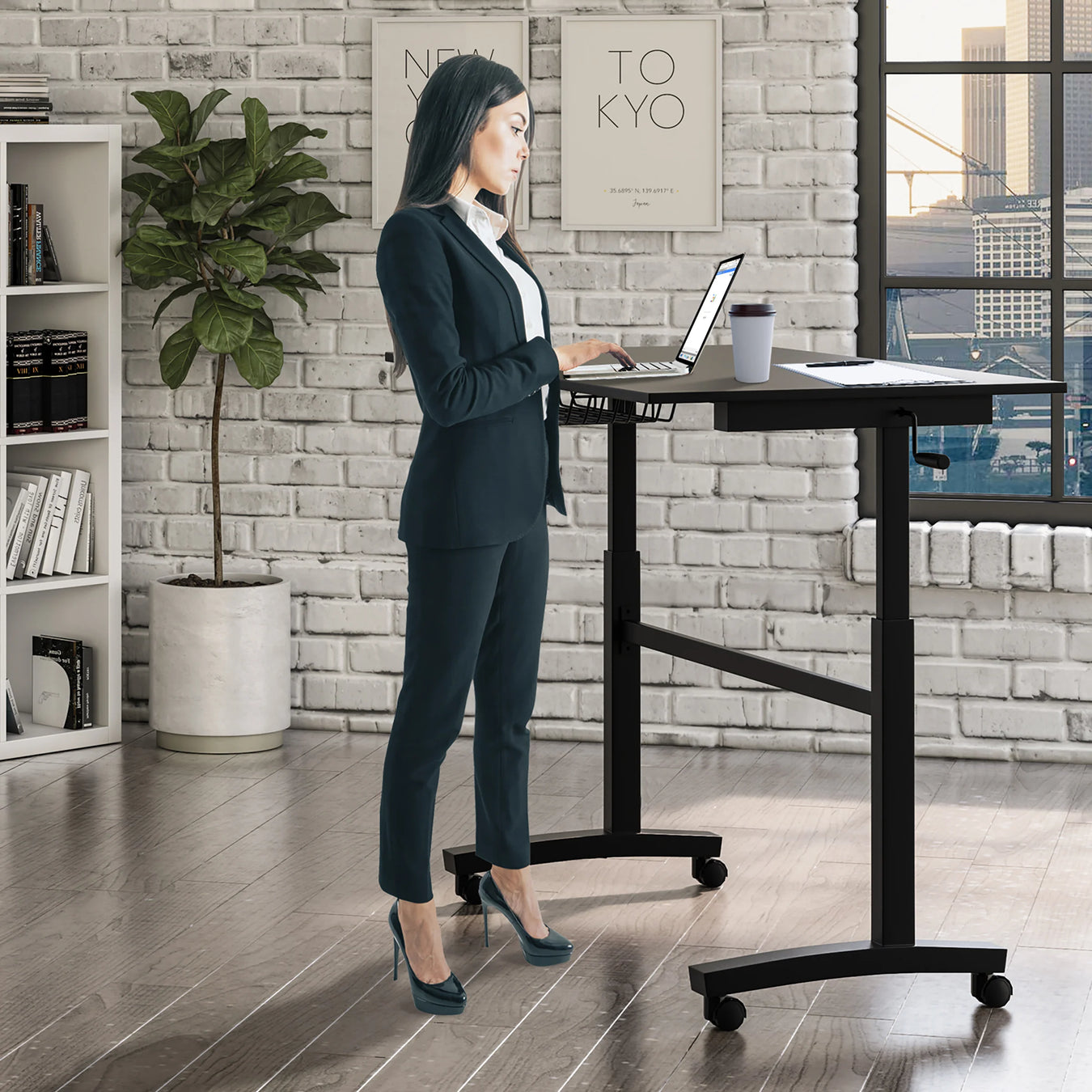 Women using the sit and stand desk in black while standing